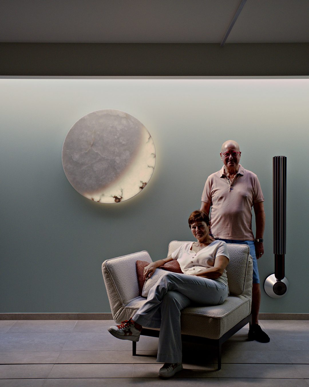 A couple beneath MOON Ninety in the lounge of a private villa