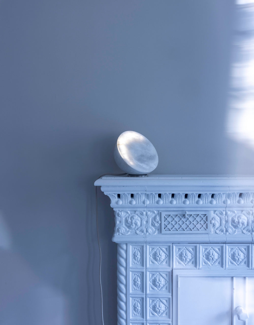 MOON Sixteen Alabaster on a carved white mantelpiece