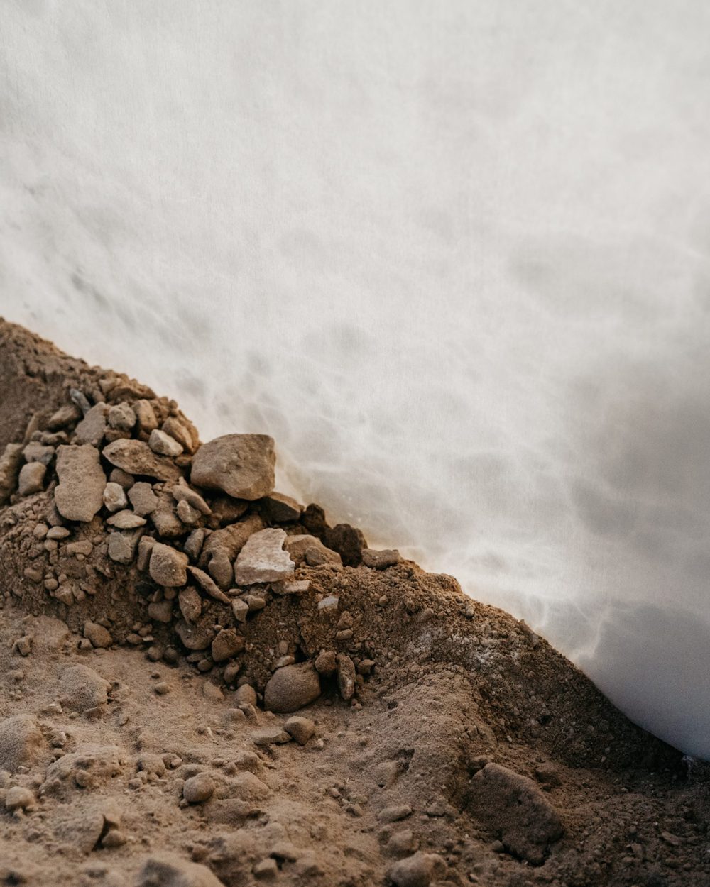 Alabaster showing through the earth of a quarry wall