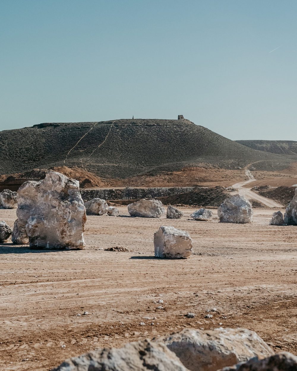 Alabaster blocks on the plateau, a hill town behind