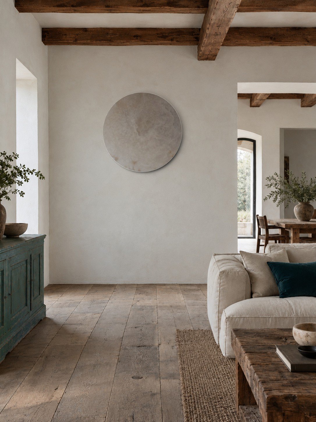 MOON on a living-room wall, unlit: a disc of pale stone