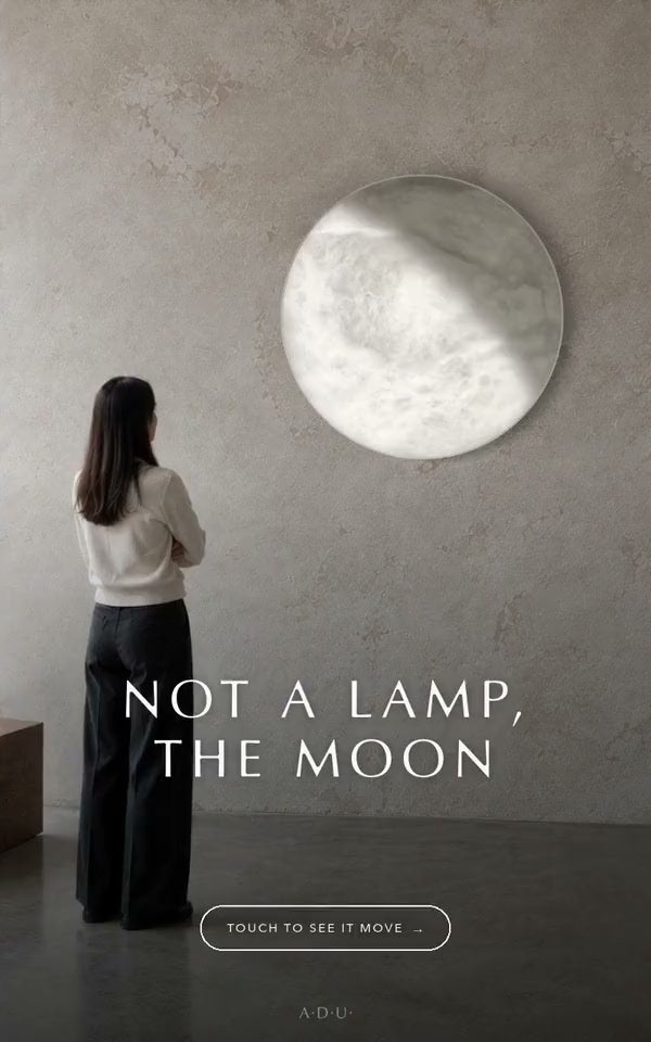 The kiosk's first screen: MOON on a wall, 'Not a lamp, the Moon', and a button to begin