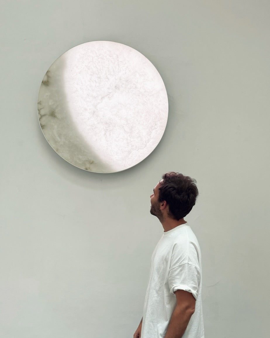 A man looks up at MOON Ninety at Lisbon by Design