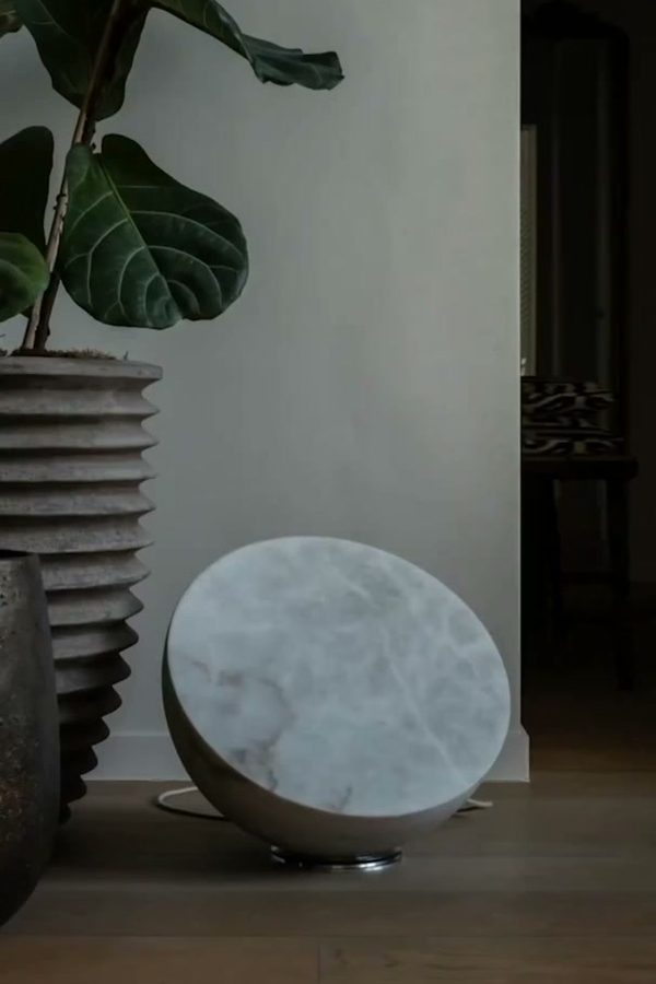 MOON Forty on a wooden floor beside a fig tree, through half a month of phases: from new moon to full moon, when the back of the stone lights up too